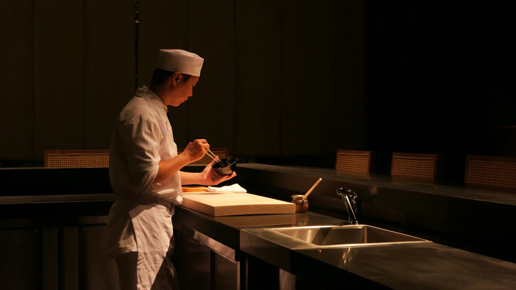 Chef alone at the dark counter